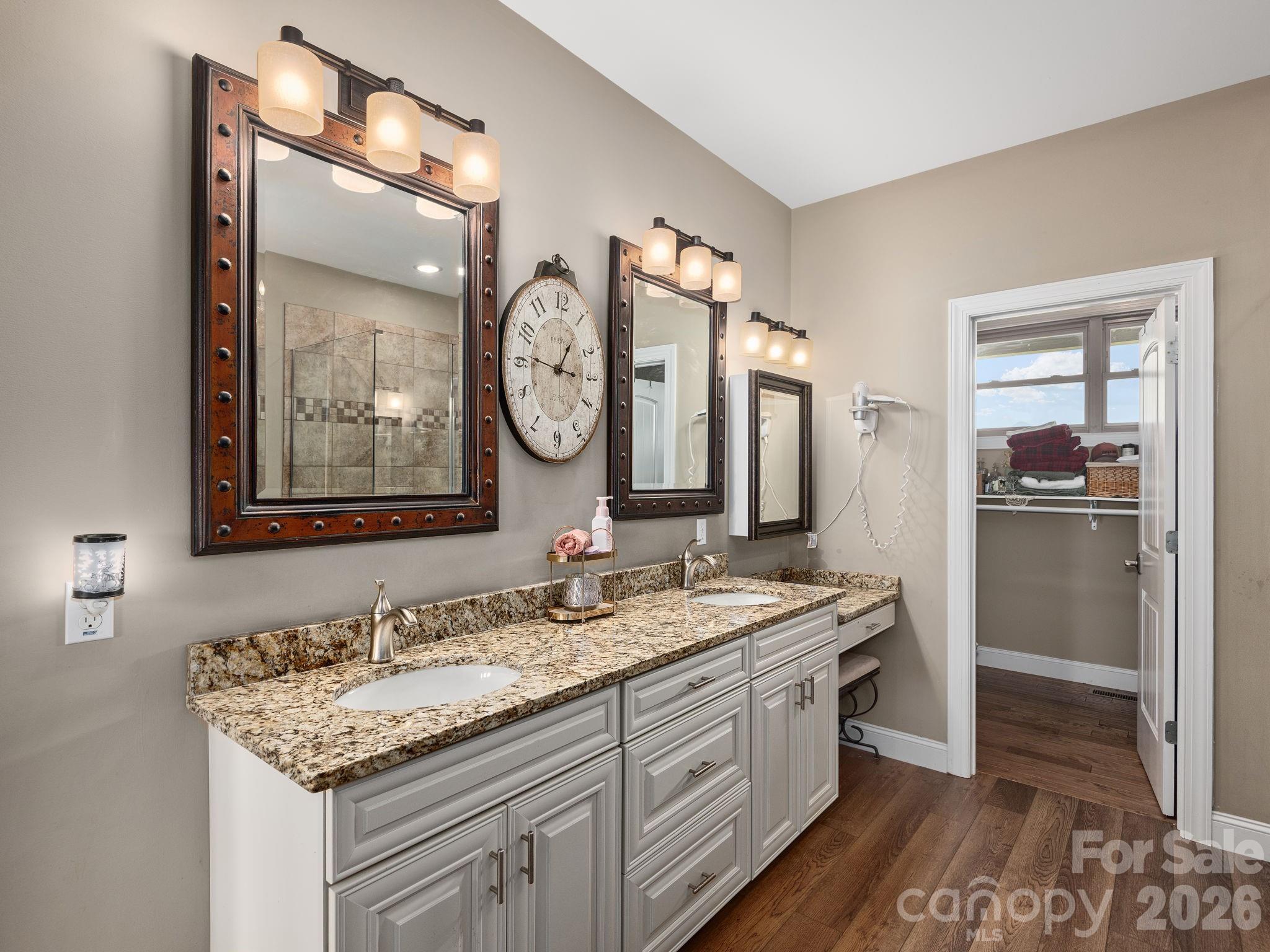 193 Youngs Cove Road Candler, NC 28715 - Photo 22 of 48 a bathroom with a granite countertop sink and a large mirror