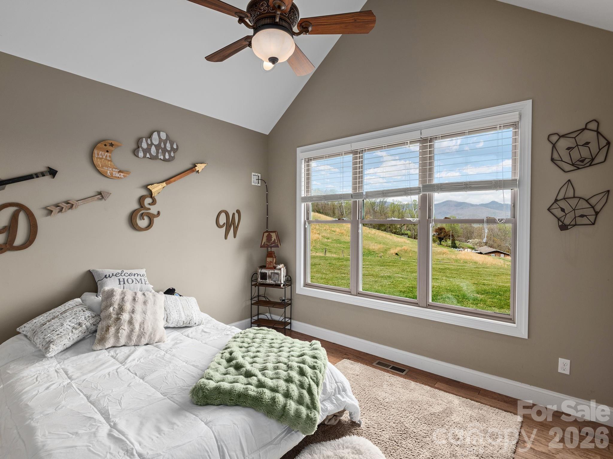 193 Youngs Cove Road Candler, NC 28715 - Photo 23 of 48 a bedroom with a bed and a window