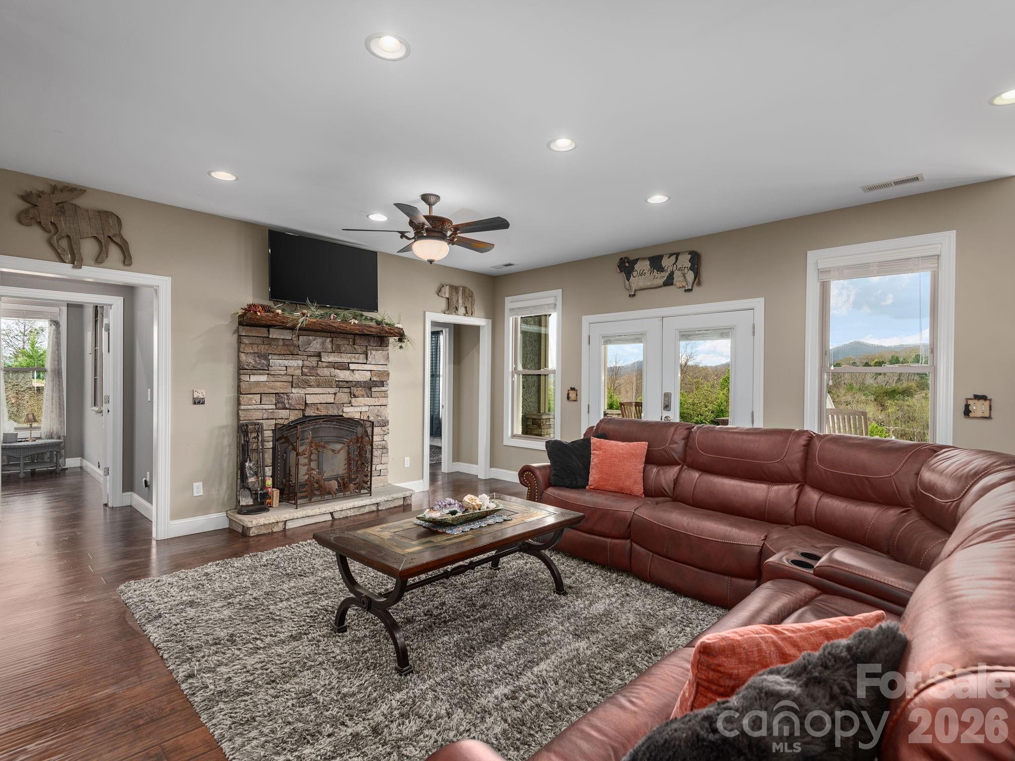 193 Youngs Cove Road Candler, NC 28715 - Photo 25 of 48 a living room with furniture a rug and a fireplace