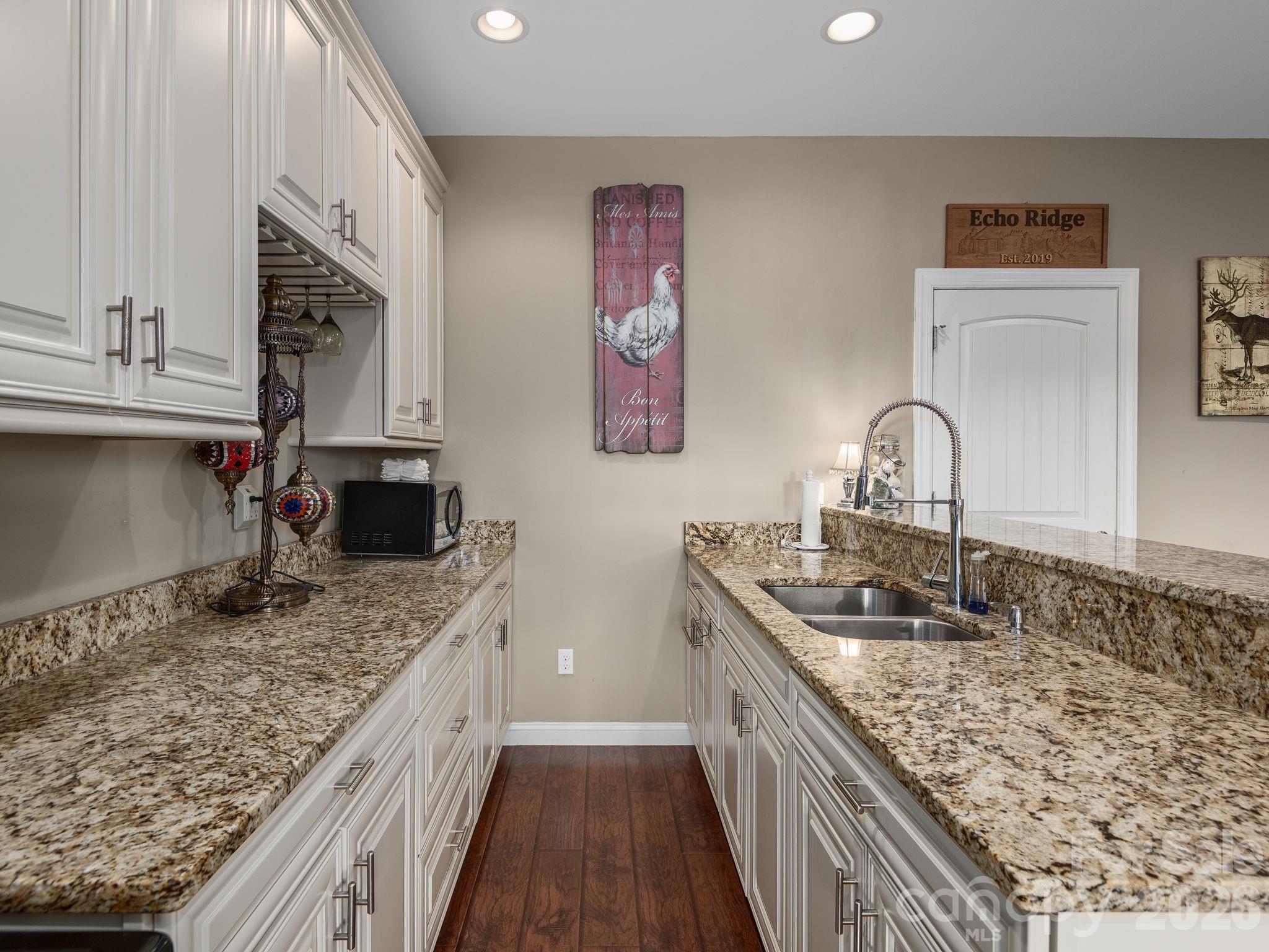 193 Youngs Cove Road Candler, NC 28715 - Photo 28 of 48 a kitchen with a sink stove and cabinets