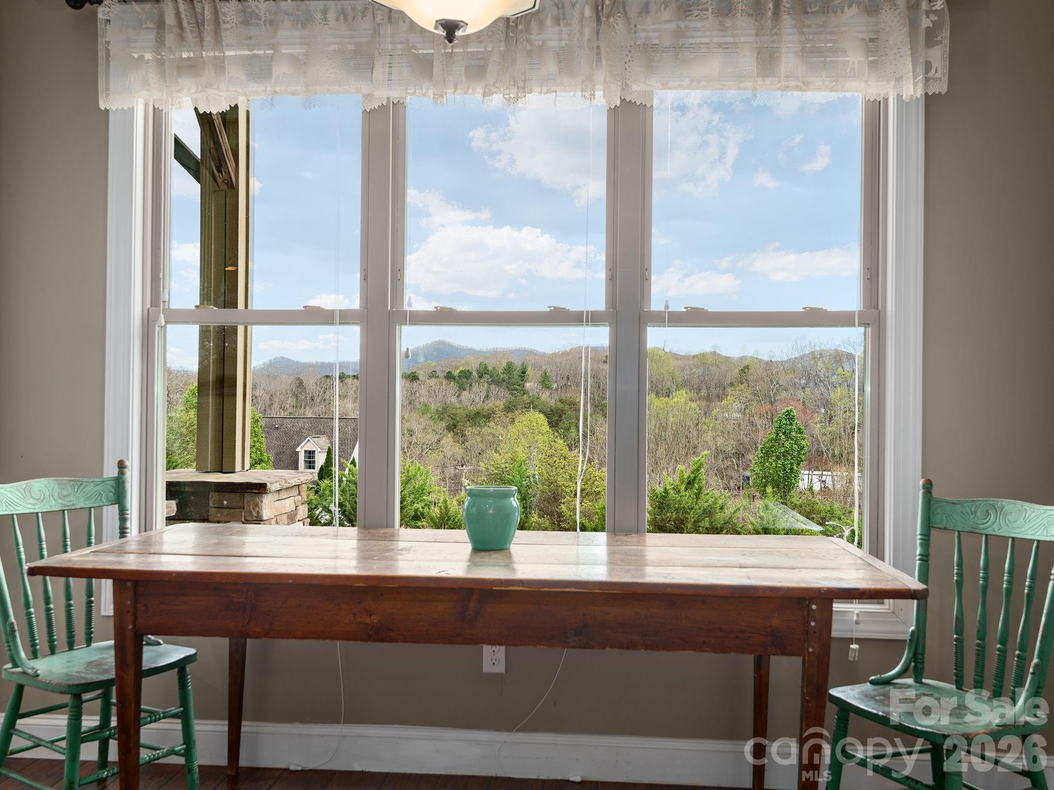 193 Youngs Cove Road Candler, NC 28715 - Photo 30 of 48 a view of a window with a table and chairs in patio