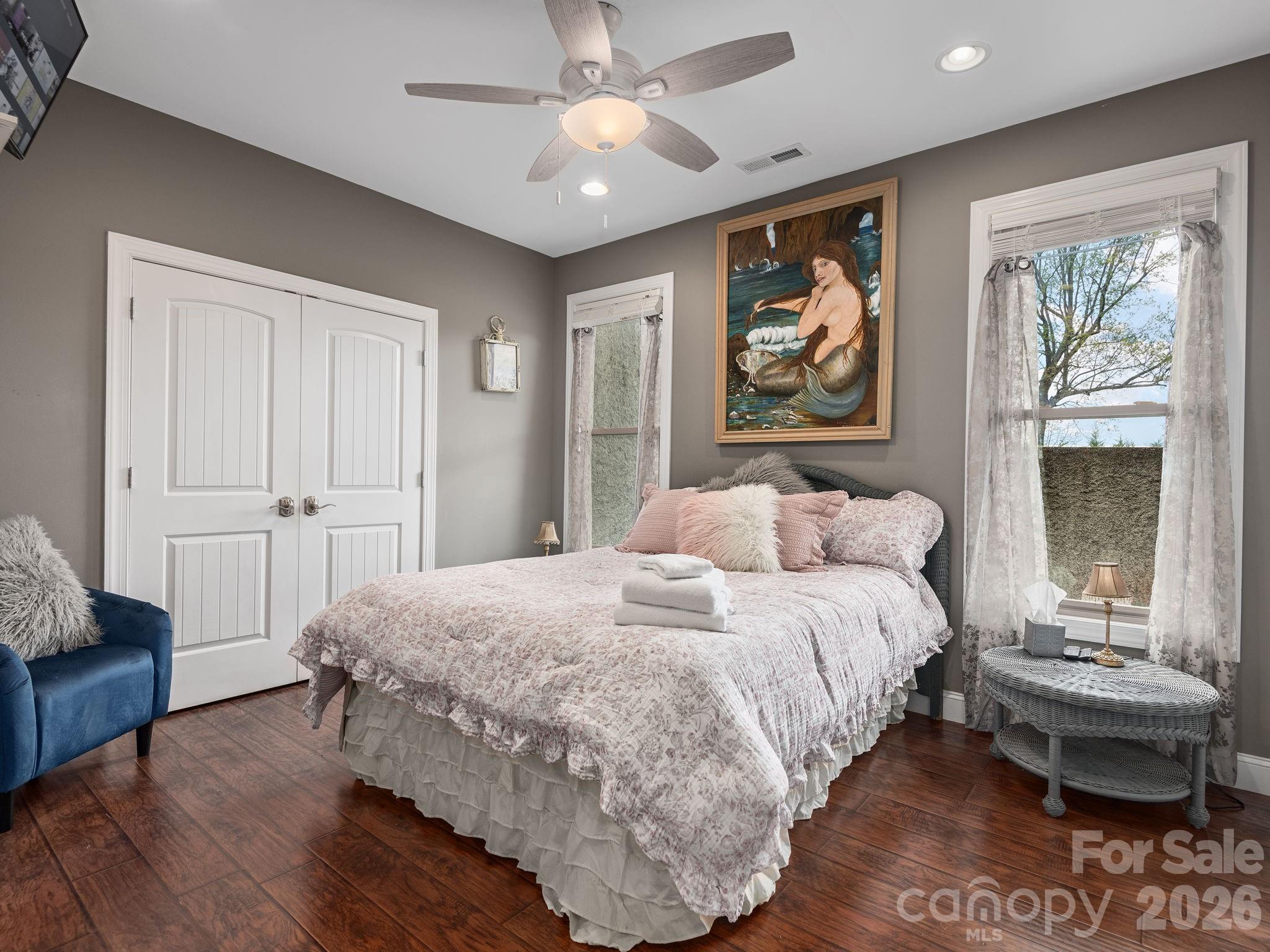 193 Youngs Cove Road Candler, NC 28715 - Photo 31 of 48 a spacious bedroom with a bed and a couch