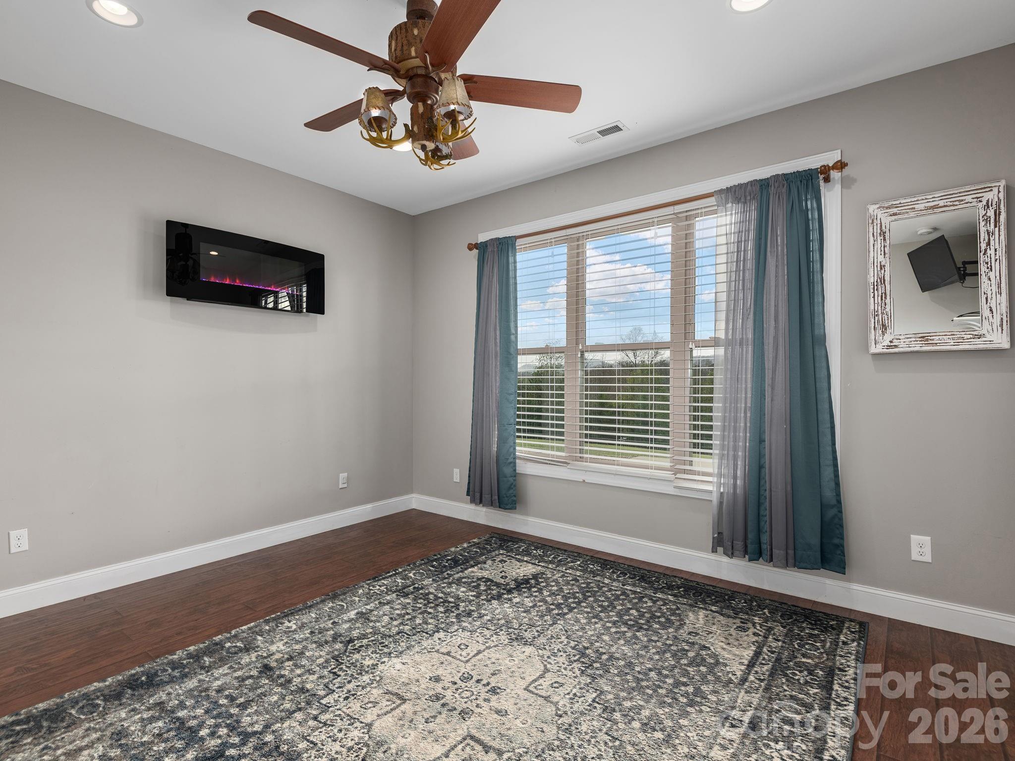 193 Youngs Cove Road Candler, NC 28715 - Photo 33 of 48 a view of a livingroom with a ceiling fan and window