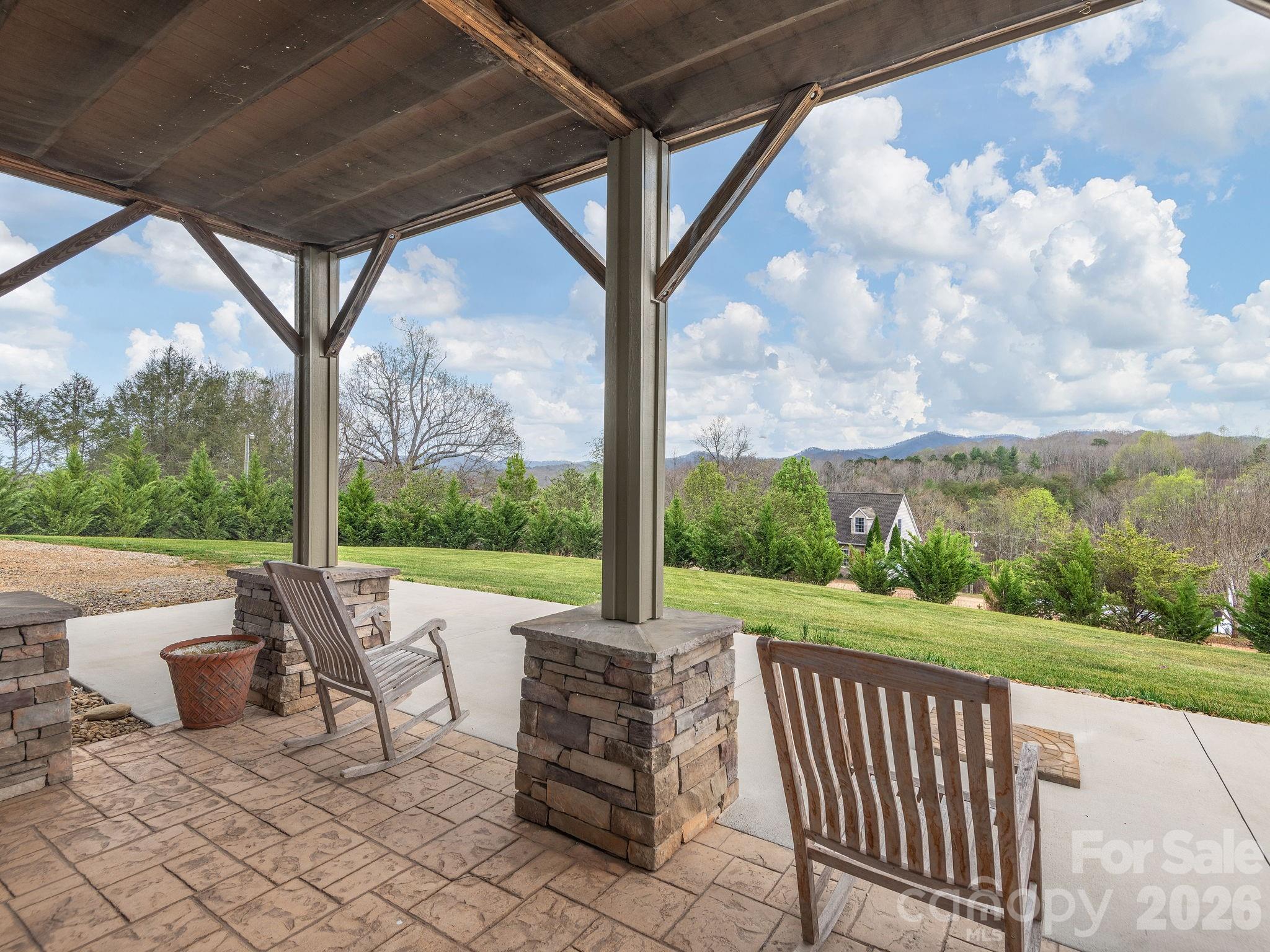 193 Youngs Cove Road Candler, NC 28715 - Photo 37 of 48 a view of a patio with a table chairs and a backyard