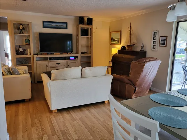 a living room with furniture window and wooden floor