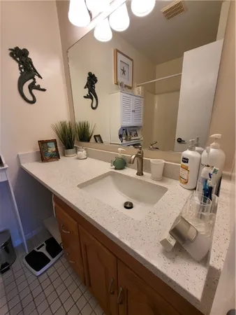 a bedroom with a bed and a dresser next to a window