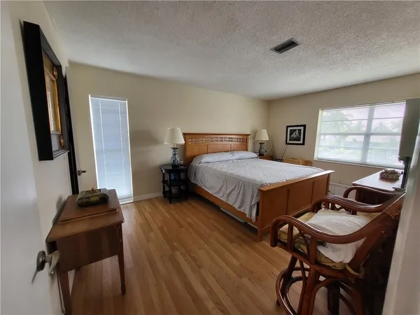 a bedroom with a bed and a large window