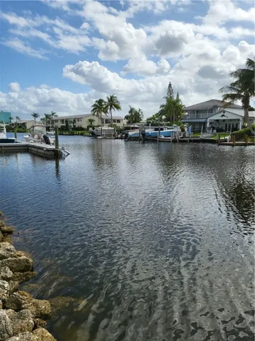 a view of a lake with houses in the back