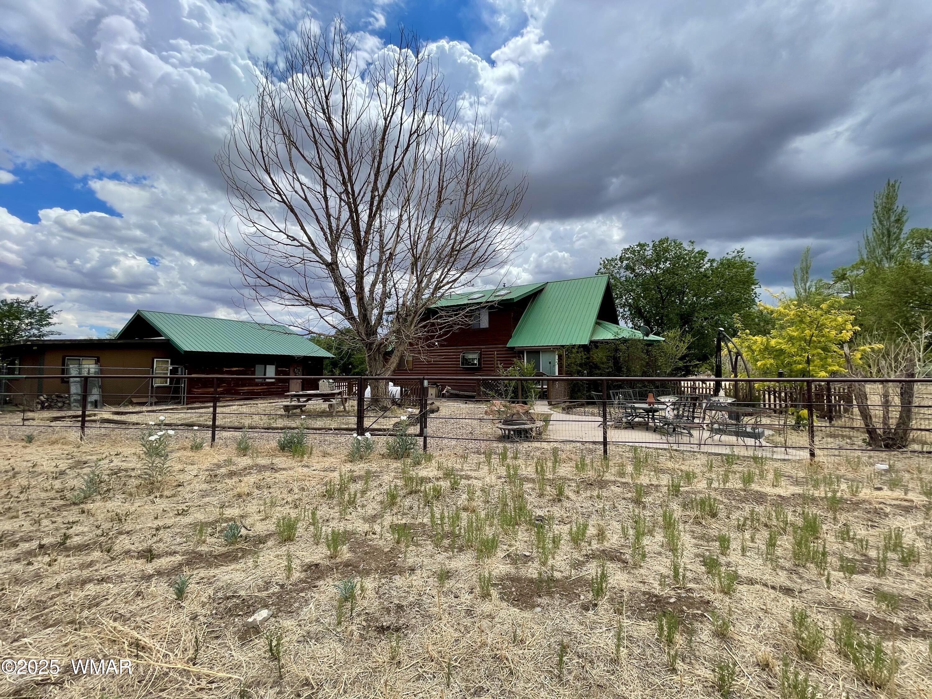 183 North Becker Lake Road Springerville, AZ 85938 - Photo 36 of 41 a backyard of a house with table and chairs