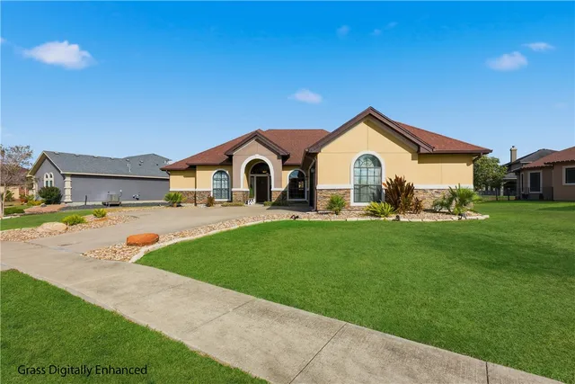 a view of a house with a yard and sitting area