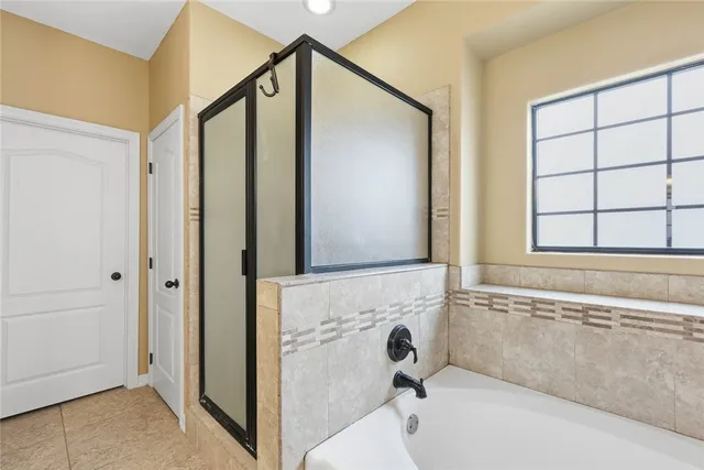 a bathroom with a tub and shower