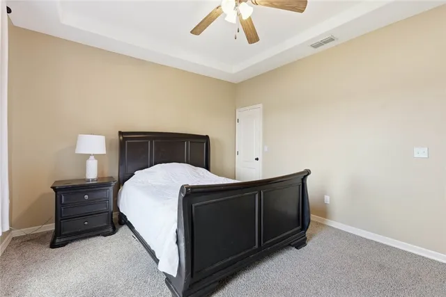 a bedroom with a bed and a night stand