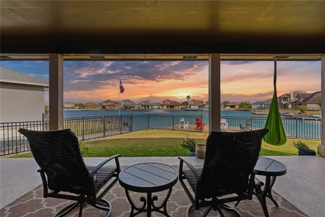 a view of a chairs and table in patio