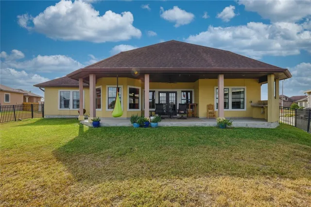a view of a house with a backyard