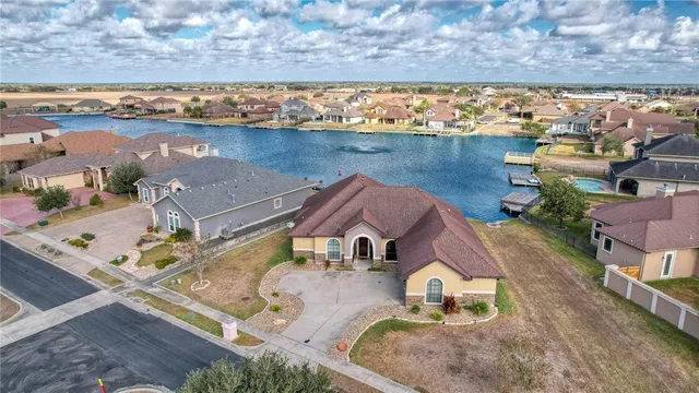 an aerial view of a house with a lake