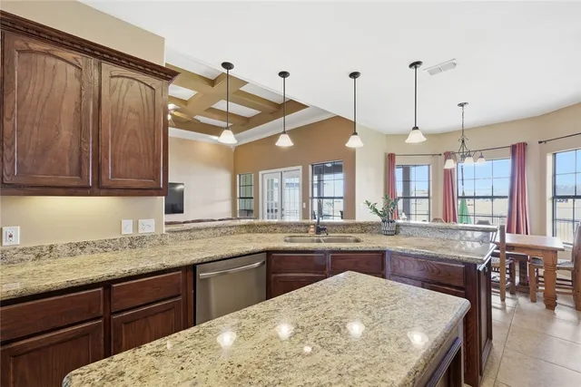 a kitchen with a stove a sink and a wooden cabinets