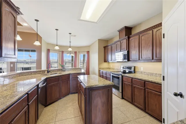 a large kitchen with granite countertop lots of counter top space