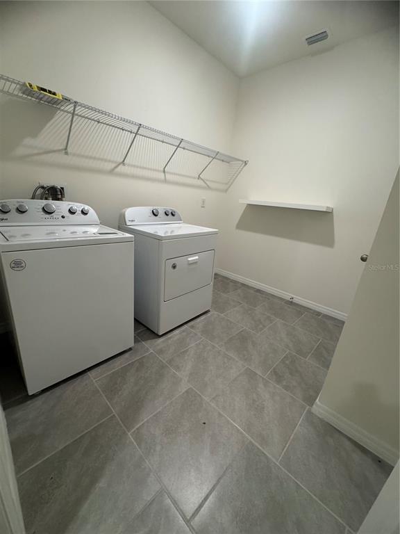 1729 Bull Hill Road Kissimmee, FL 34744 - Photo 14 of 34 a utility room with dryer and washer