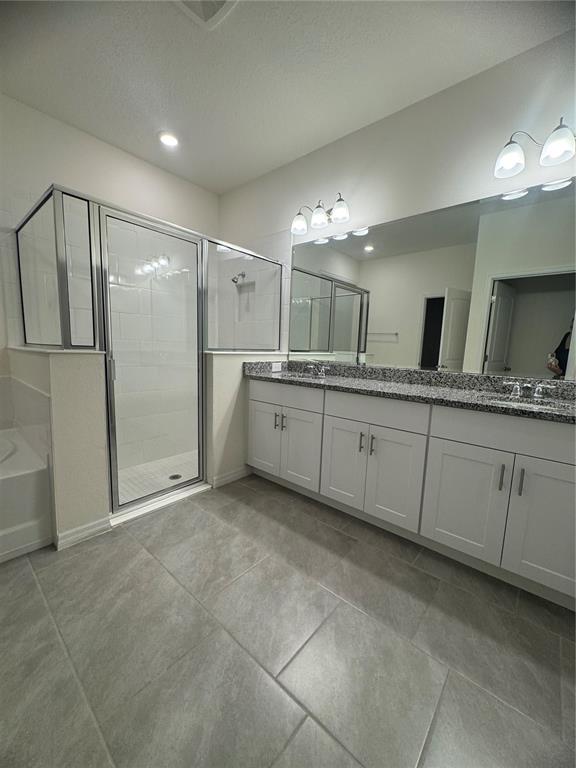 1729 Bull Hill Road Kissimmee, FL 34744 - Photo 15 of 34 a bathroom with a granite countertop sink mirror and shower
