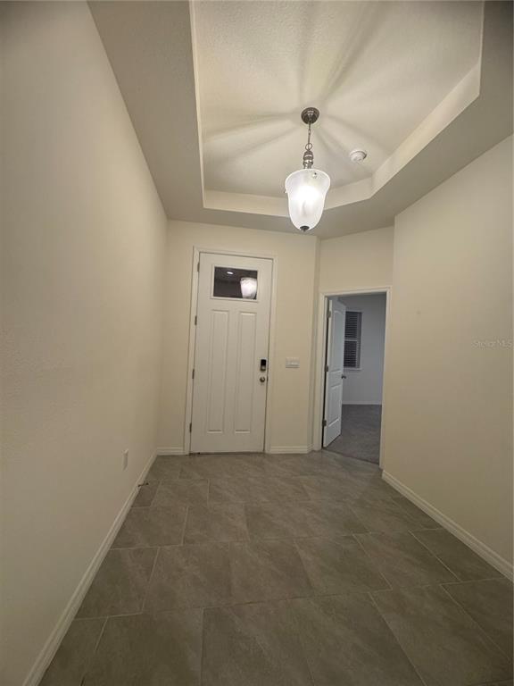1729 Bull Hill Road Kissimmee, FL 34744 - Photo 19 of 34 an empty room with chandelier fan and windows