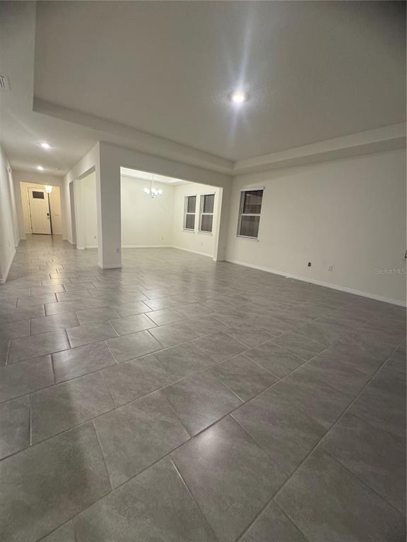 1729 Bull Hill Road Kissimmee, FL 34744 - Photo 5 of 34 a view of a hallway with wooden floor