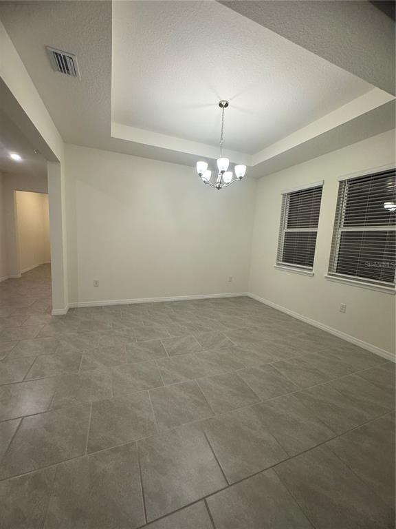 1729 Bull Hill Road Kissimmee, FL 34744 - Photo 6 of 34 a view of a livingroom with a fireplace a chandelier and windows