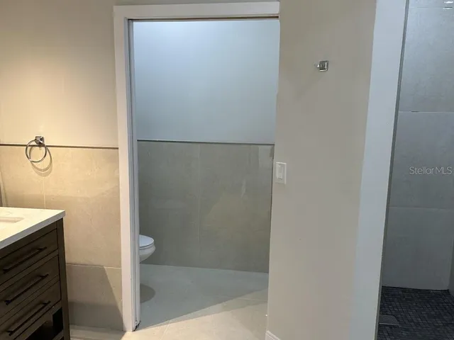 a bathroom with a glass shower door