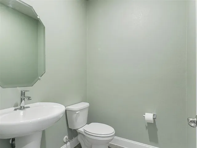 a white toilet sitting next to a white sink