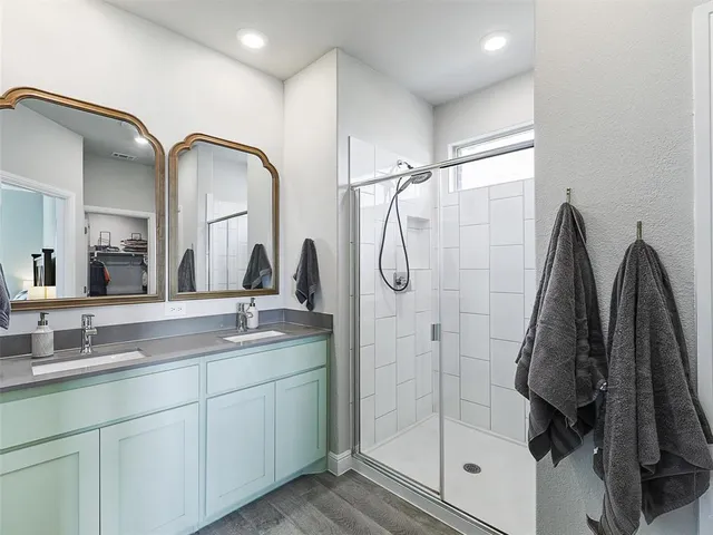 a bathroom with a double vanity sink and mirror