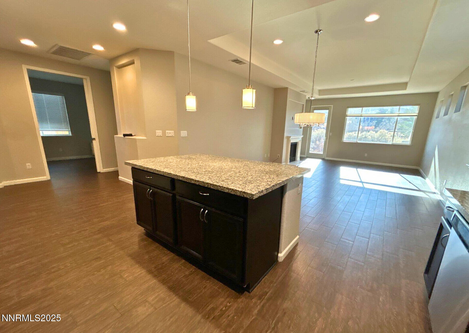 6517 Angels Orchard Drive Sparks, NV 89436 - Photo 4 of 20 a kitchen with stainless steel appliances granite countertop a sink a counter space and wooden floor