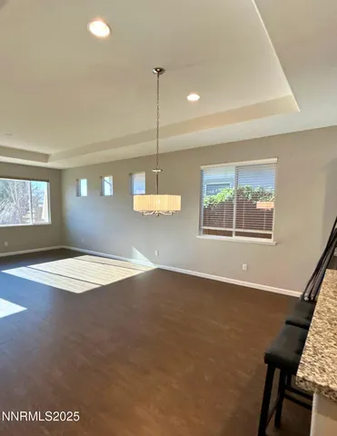 a view of a livingroom with wooden floor and a window