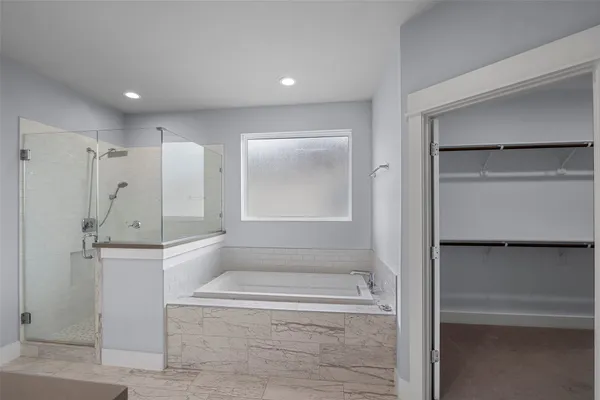 a bathroom with a bathtub and a shower