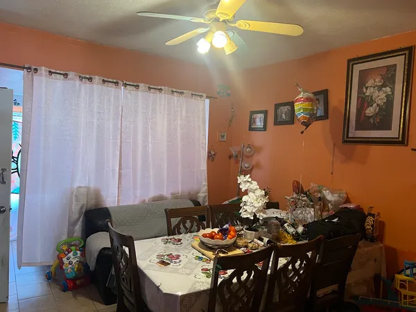 a view of a dining room with furniture and chandelier