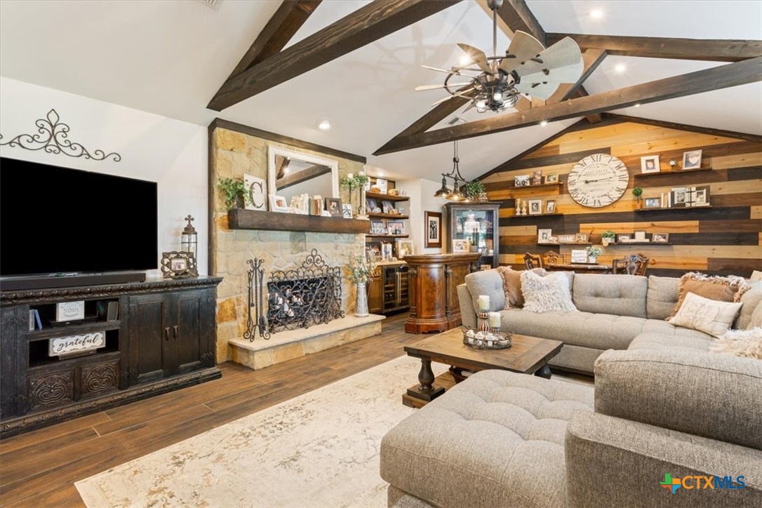 6409 3 Forks Road Belton, TX 76513 - Photo 16 of 40 a living room with furniture a flat screen tv and a fireplace