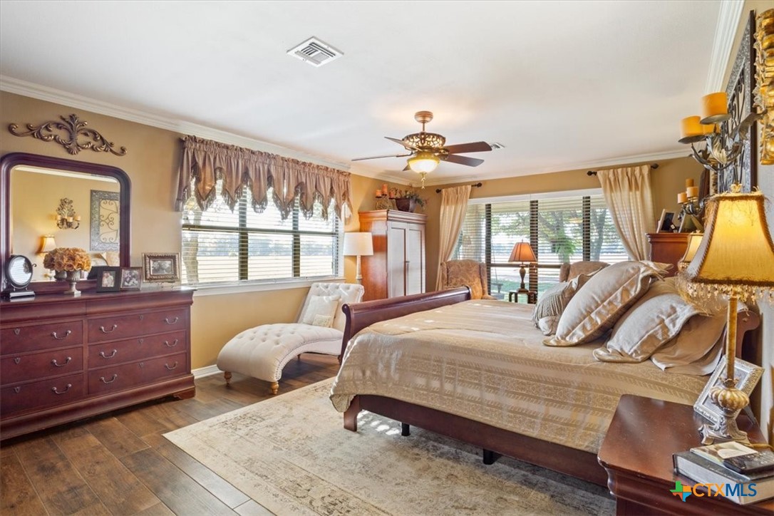 6409 3 Forks Road Belton, TX 76513 - Photo 26 of 40 a bedroom with a bed and wooden floor