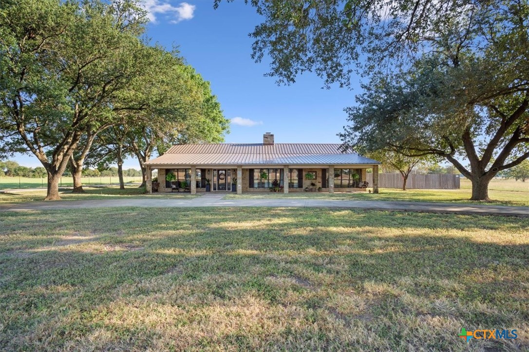 6409 3 Forks Road Belton, TX 76513 - Photo 3 of 40 a front view of a house with a garden