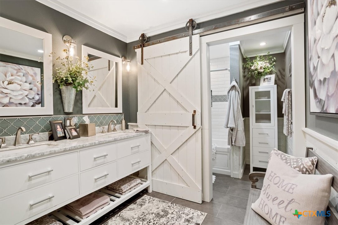 6409 3 Forks Road Belton, TX 76513 - Photo 33 of 40 a bathroom with a granite countertop sink mirror and a shower