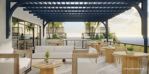 a living room with couches and a table with garden view