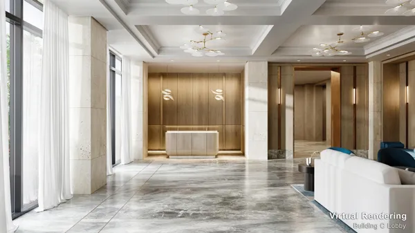 a view of a hallway with furniture and a chandelier