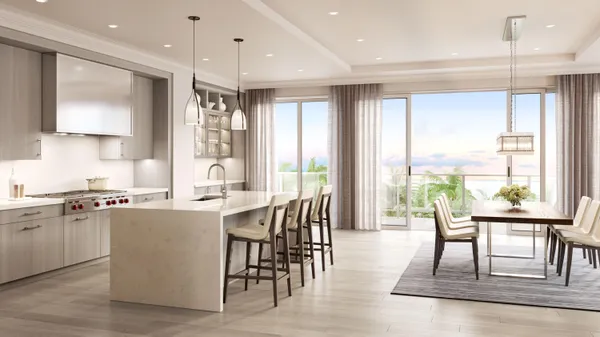 a kitchen with stainless steel appliances granite countertop table chairs stove and sink