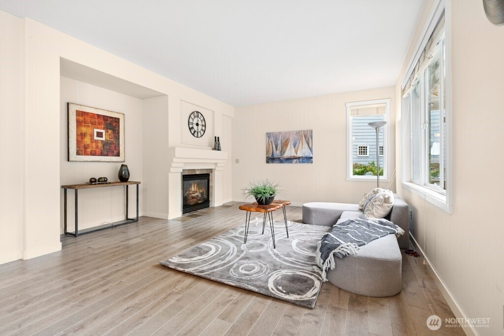 1807 Northeast 26th Place Renton, WA 98056 - Photo 13 of 38 a living room with furniture two window and a fireplace