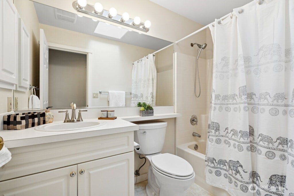 1807 Northeast 26th Place Renton, WA 98056 - Photo 27 of 38 a bathroom with a double vanity sink toilet and shower