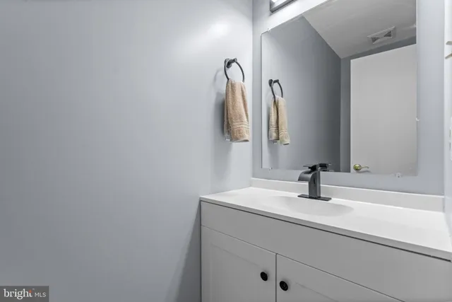 a bathroom with a sink and vanity