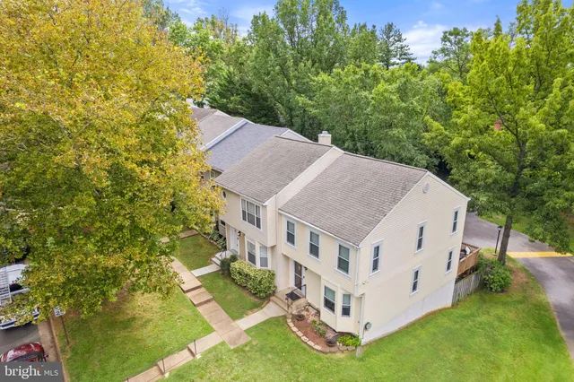 a aerial view of a house with a yard table and chairs