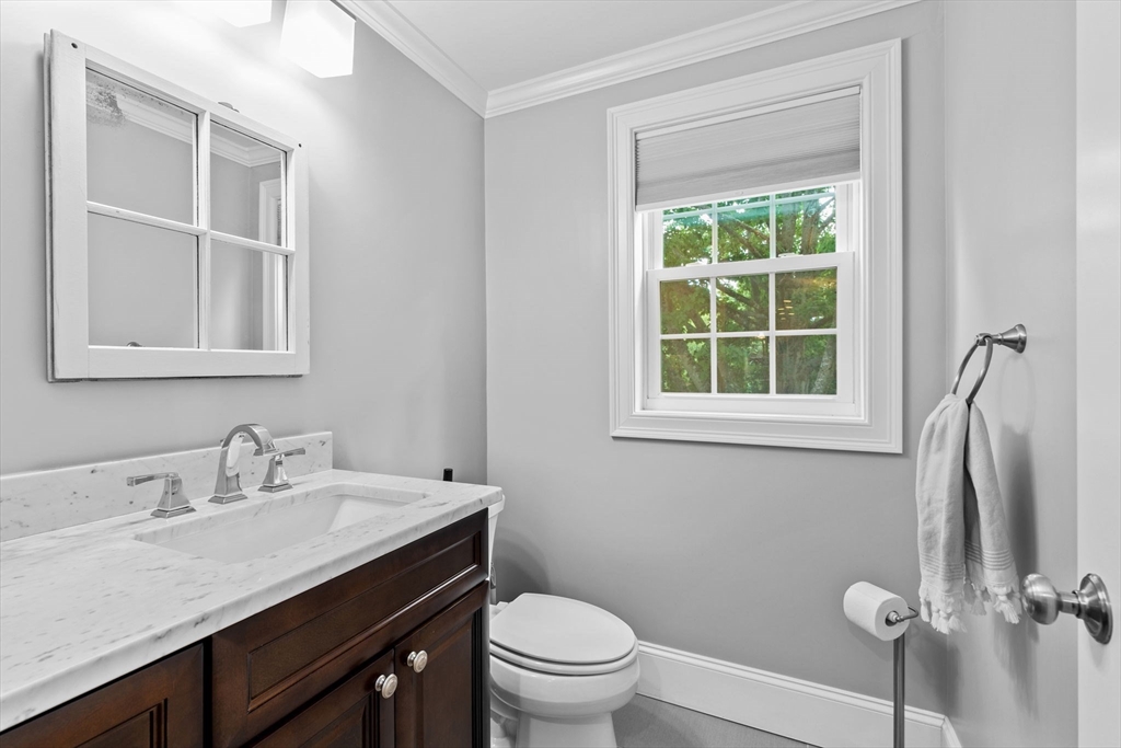 48 Atwill Road Boston, MA 02132 - Photo 13 of 36 a bathroom with a granite countertop sink toilet and a window
