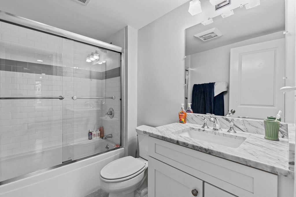 48 Atwill Road Boston, MA 02132 - Photo 22 of 36 a bathroom with a granite countertop sink a toilet and shower