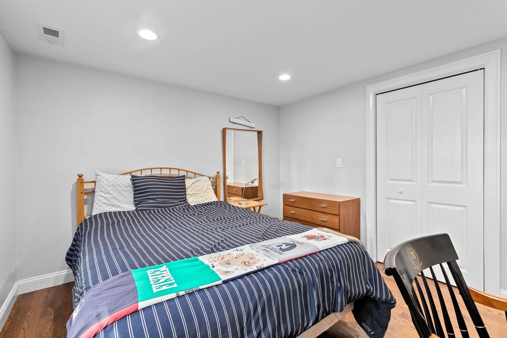 48 Atwill Road Boston, MA 02132 - Photo 27 of 36 a bedroom with a bed and wooden floor