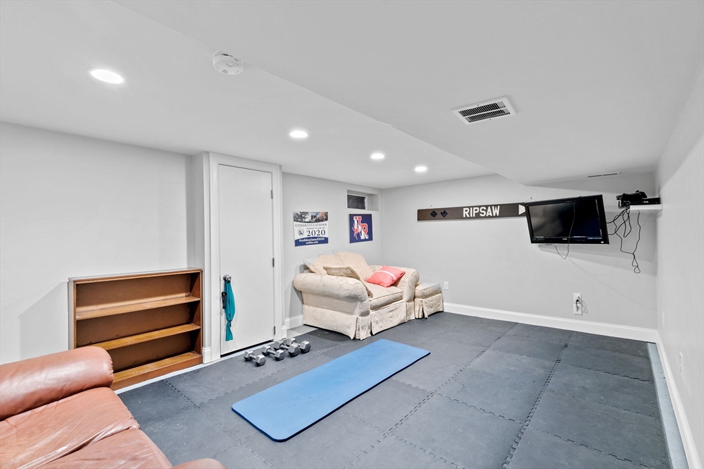 48 Atwill Road Boston, MA 02132 - Photo 30 of 36 a living room with furniture and a flat screen tv
