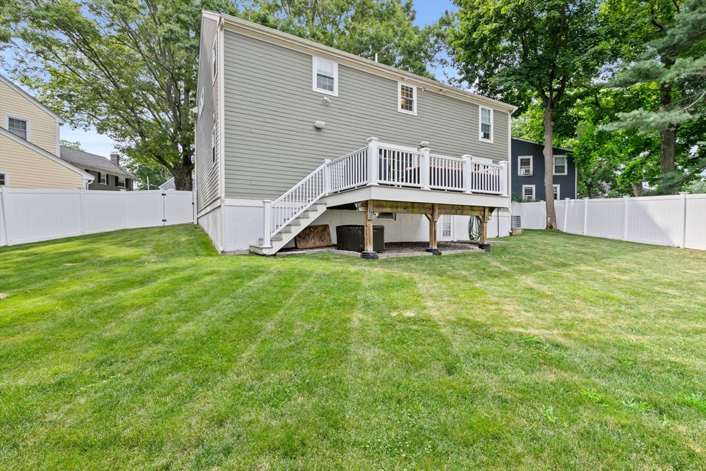 48 Atwill Road Boston, MA 02132 - Photo 34 of 36 a view of a white house with a big yard and large trees