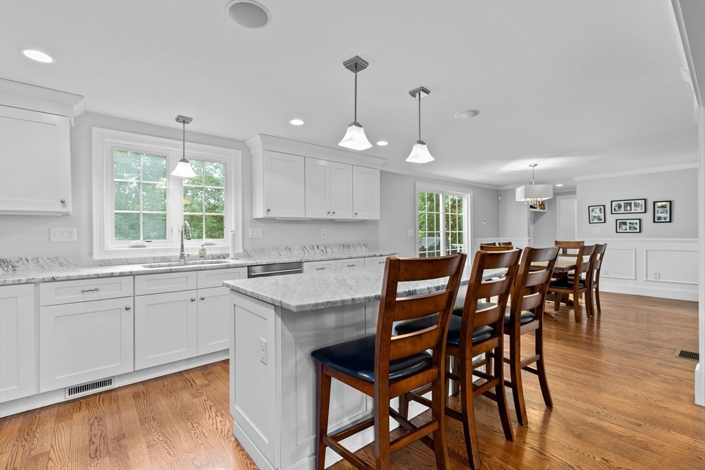48 Atwill Road Boston, MA 02132 - Photo 9 of 36 a kitchen with stainless steel appliances granite countertop a dining table chairs and white cabinets